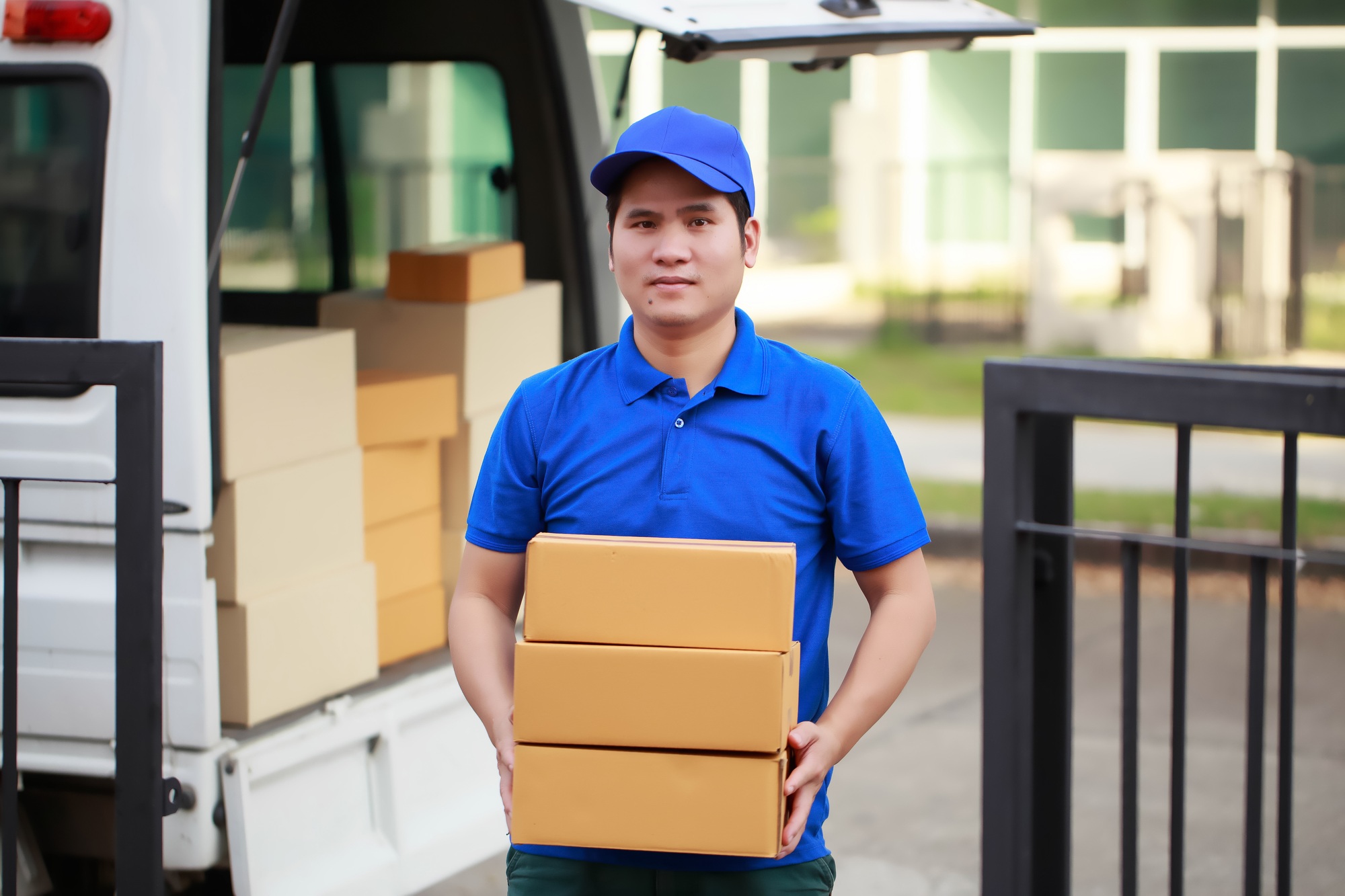 The courier is carefully inspecting the package for authenticity before delivering it to the custome